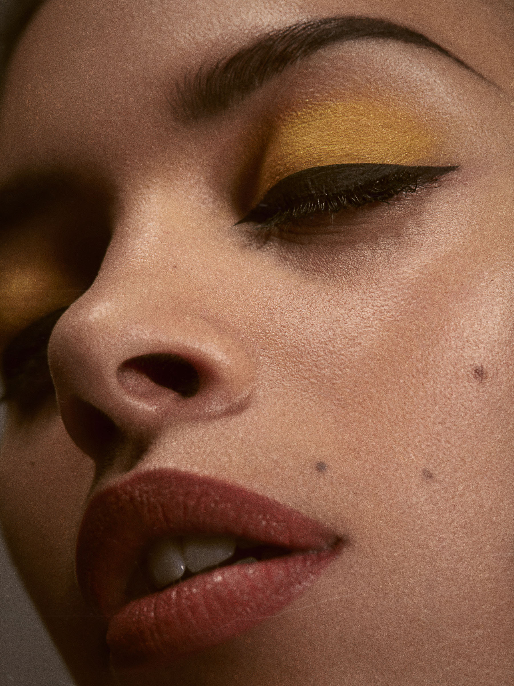 Makeup close-up of a woman wearing yellow eyeshadow